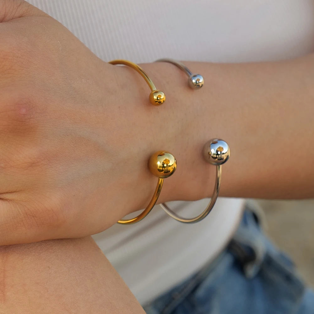 Pulsera acero inoxidable en oro de 18 quilates con doble bola