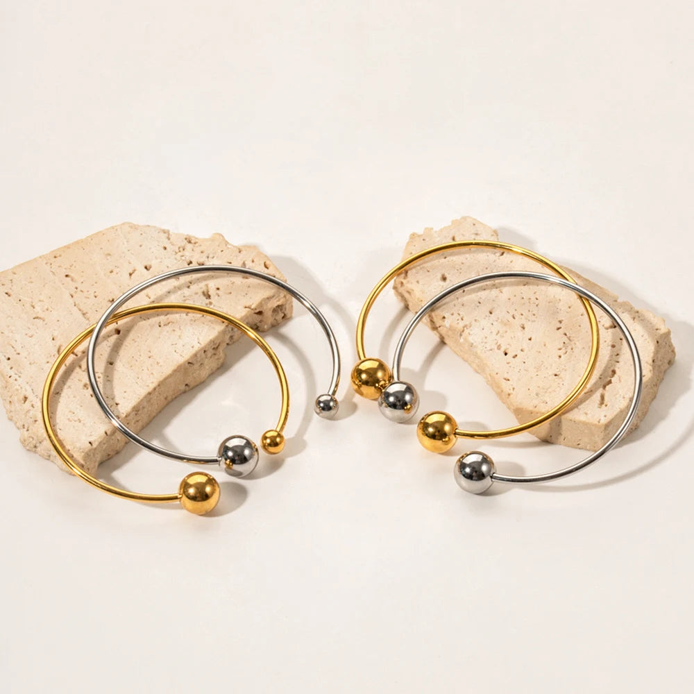 Pulsera acero inoxidable en oro de 18 quilates con doble bola