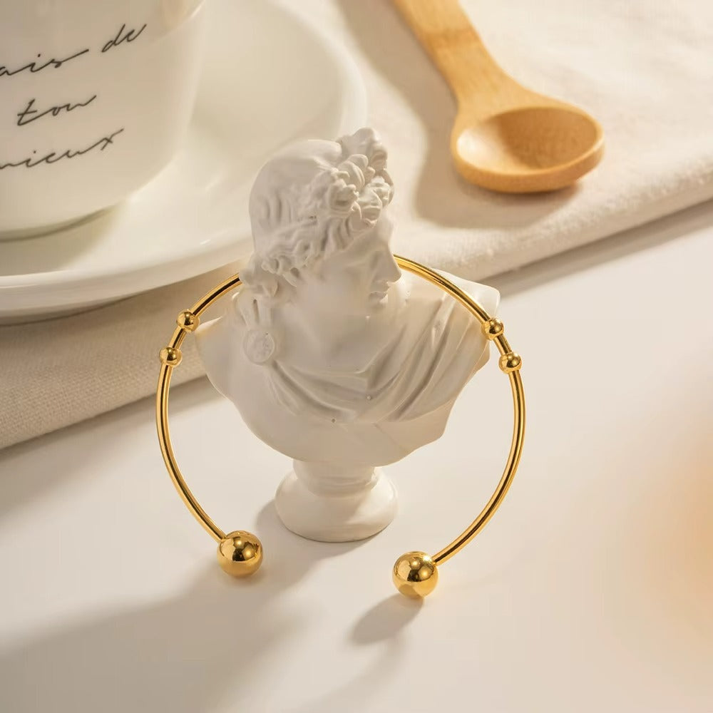 Pulseras acero inoxidable con bolas redondas en oro de 18 K